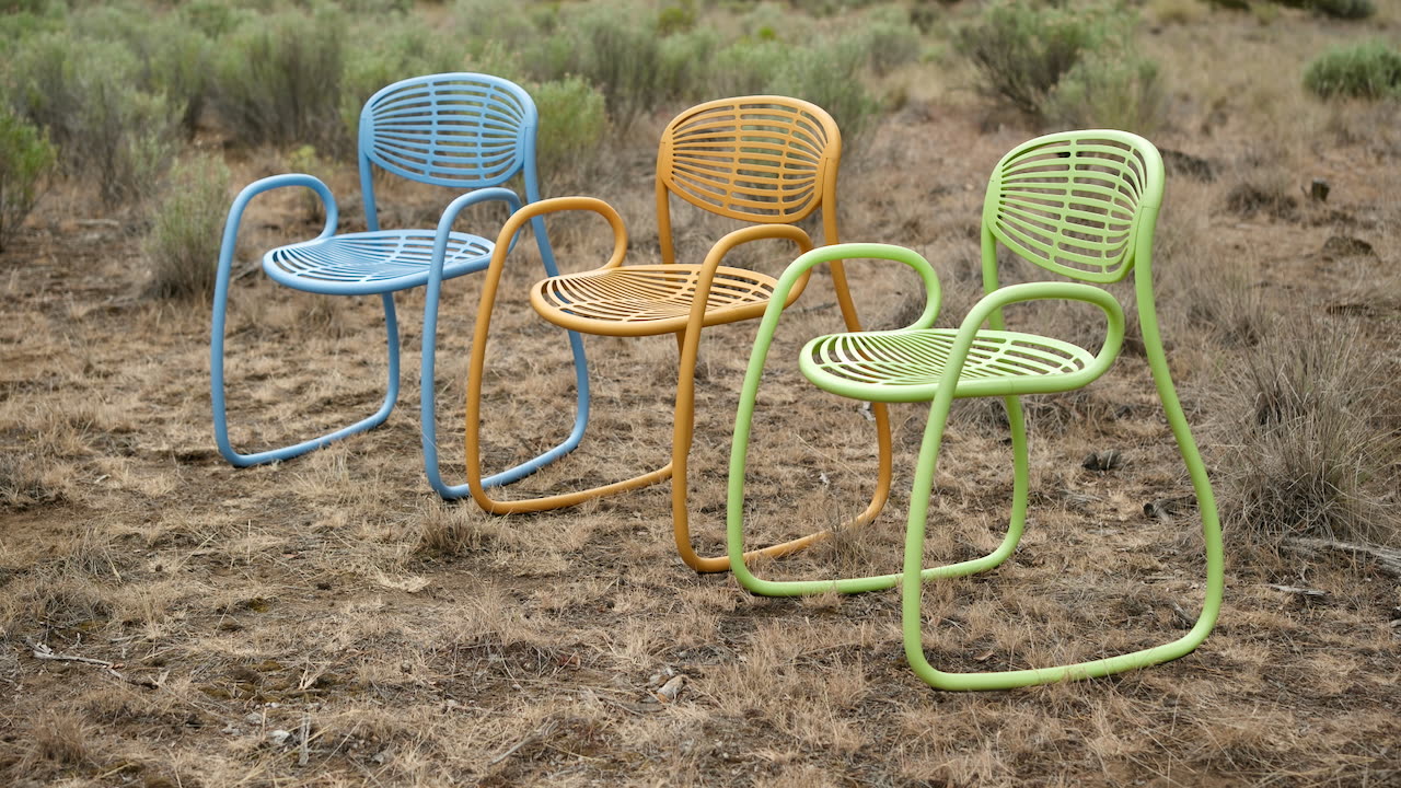 Three Vibe chairs, blue, turmeric and sage, standing together in high-desert sagebrush outside Bend, Oregon