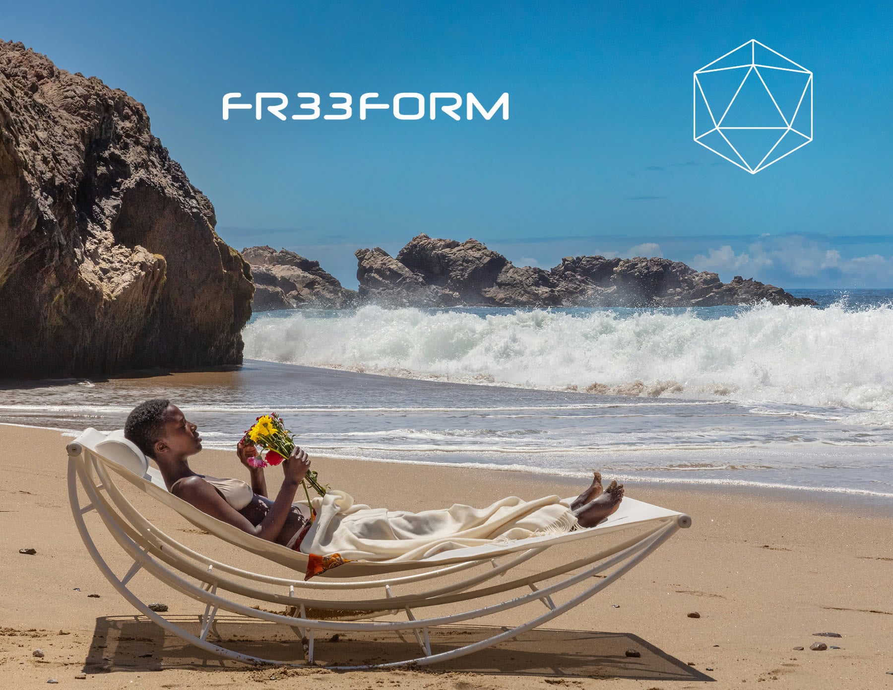 FR33FORM, a woman resting in a white Volo lounge on a beach as a wave breaks behind her