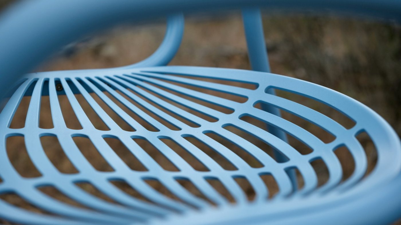 Close detail of a Troll Blue Vibe, the seat slats fanning into the bent frame
