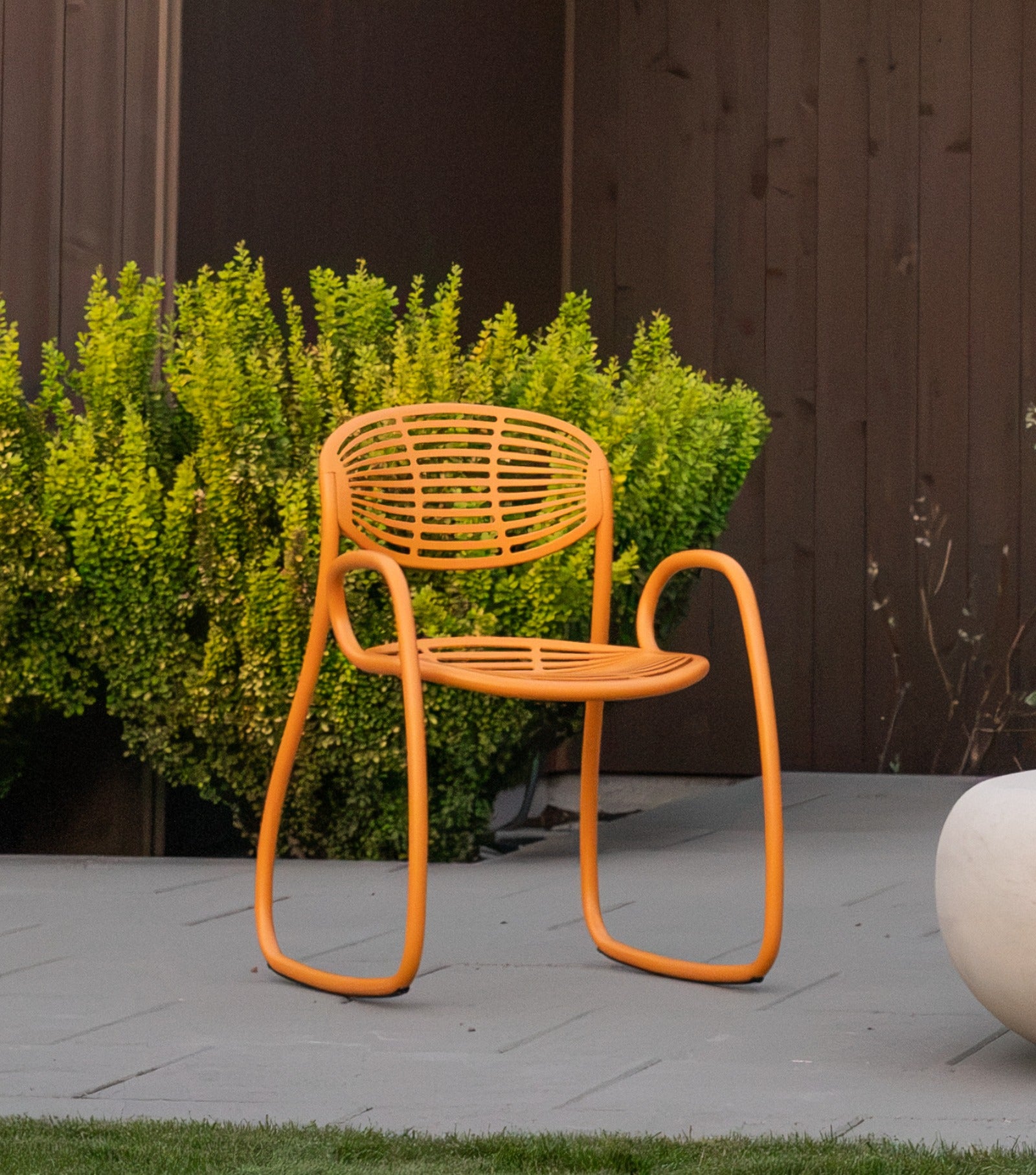 A Matte Cascade Peach Vibe chair on a stone patio at dusk, Bend, Oregon