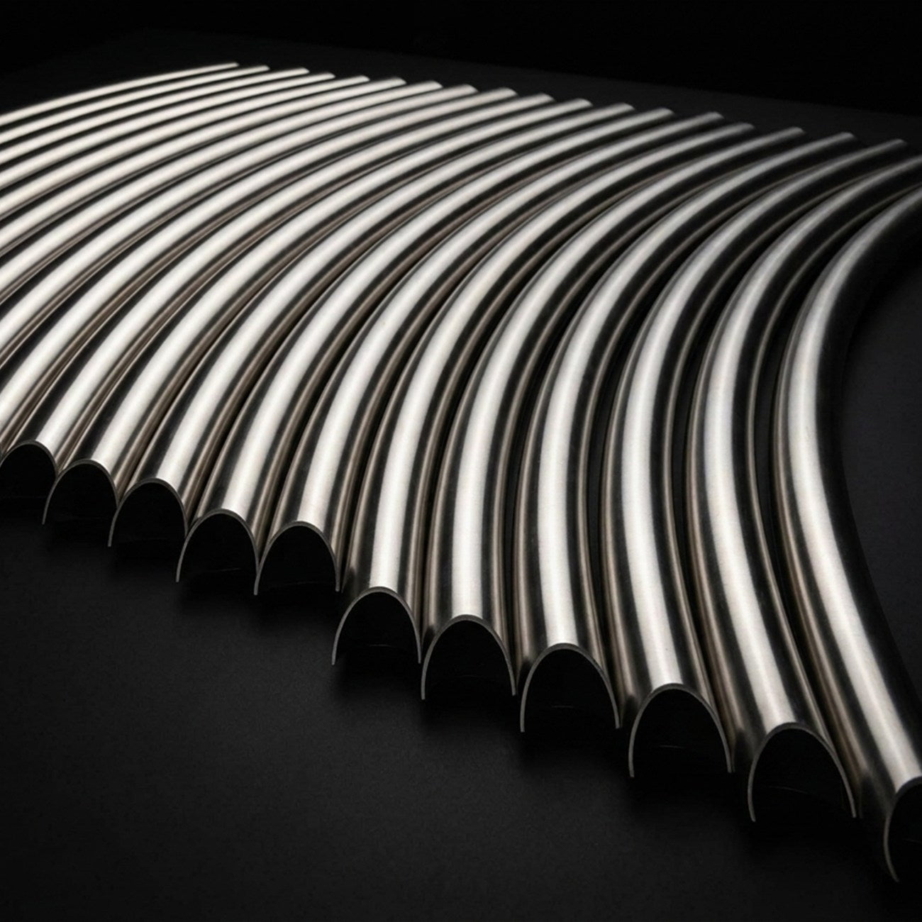 Laser cut arced tubes of identical length, laid side by side on matte black